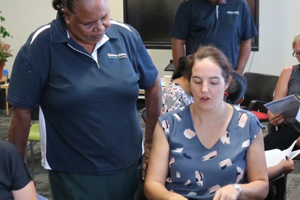 corporate work environment with aboriginal staff speaking to other staff