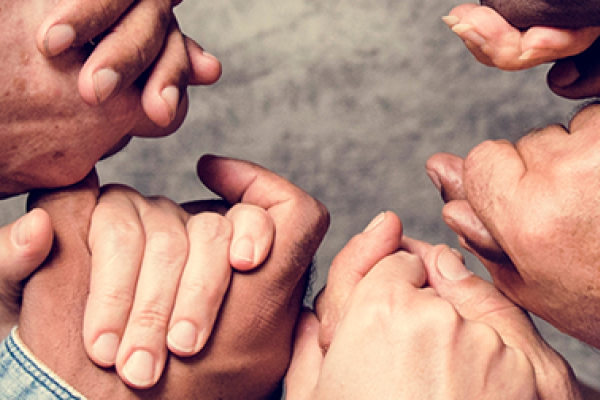 Group of people holding hands